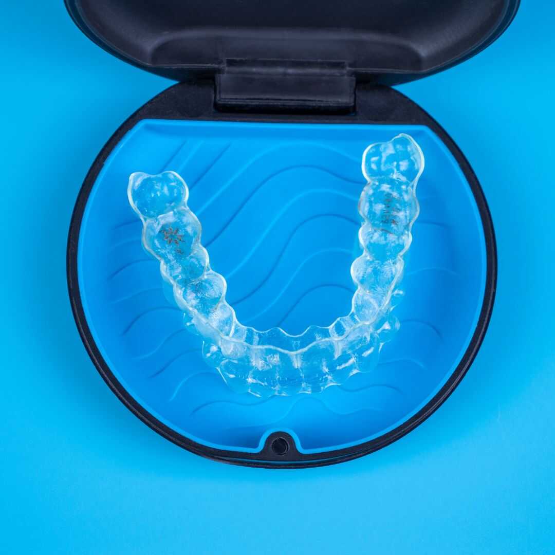 A clear aligner stored in its protective case