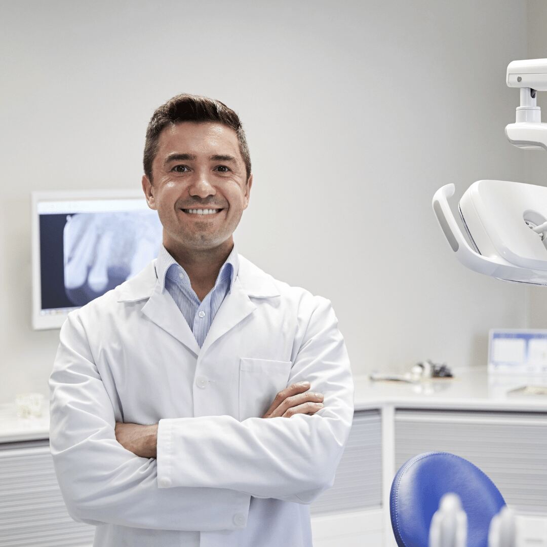 A dentist standing in the treatment room at the clinic