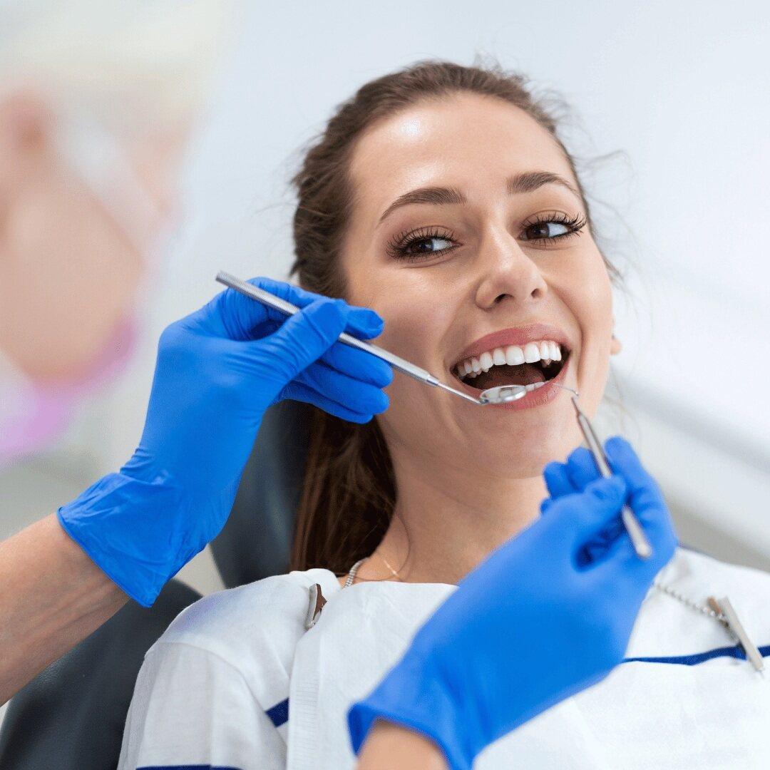 A patient smiling during a check-up after a tooth extraction
