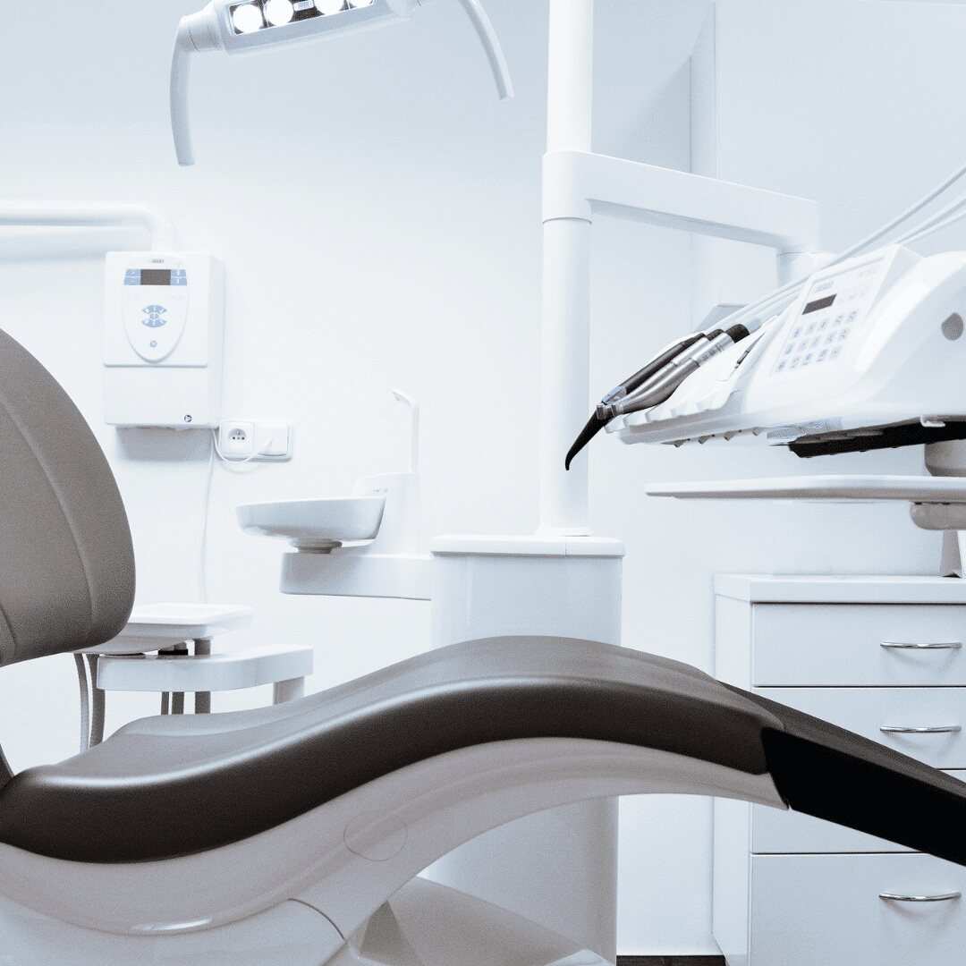 An empty dental chair and treatment unit ready for the next patient
